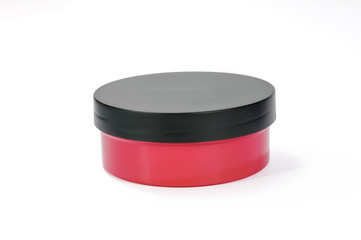 Round red and black plastic case with screw lid on white background