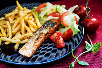 Grilled Salmon with fresh lettuce and Golden French fries