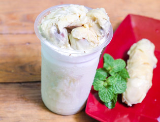 Milkshake with durian pieces, in  plastic cup, delicious and fresh.