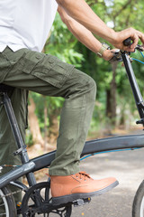 Obraz premium Man with cargo pants riding a bicycle in the garden