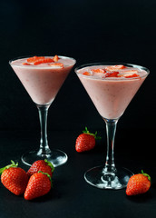 Glasses of milkshake with strawberries