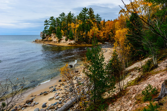 Stone coast in Pictured Rocks National Lakeshore, USA. Autumn forest on coast.