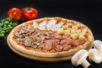 Appetizing fresh pizza Four Seasons with bacon, mozzarella, chicken, mushrooms and pineapple on wooden board on dark background