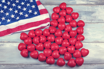 Many hearts and American flag on a wooden surface