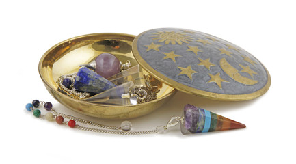 Selection of Radionics Dowsing Pendants - Brass dish on a white background containing three...