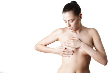 Studio Shot Of Naked Woman Woman Examining Breast