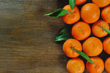 Wooden background with orange clementine