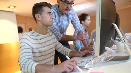 Students attending web design class with teacher