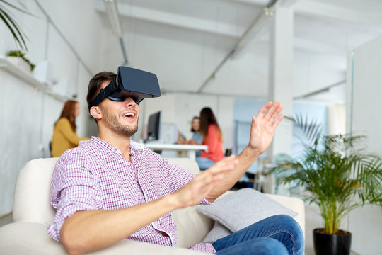 happy man with virtual reality headset at office