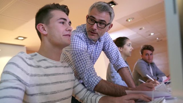 Students attending web design class with teacher