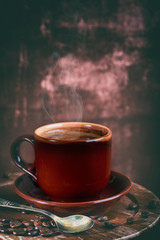 Coffee cup and coffee beans on table