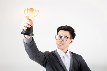 .The winner holding gold trophy. Studio shot on white background.