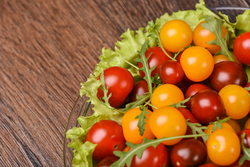 Cherry tomatoes  with arugula in a glass plate