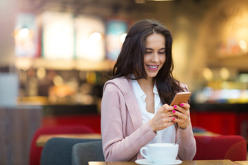 Young woman drinking coffee in cafe
