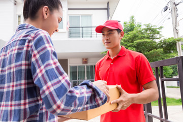 Woman accepting a delivery of boxes from delivery service courier. Isolated on a White Background.