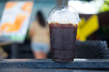 Iced black coffee in a plastic glass
