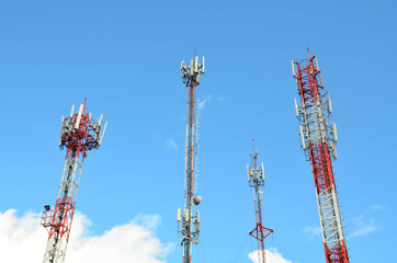 Group of telecommunication towers against blue sky background