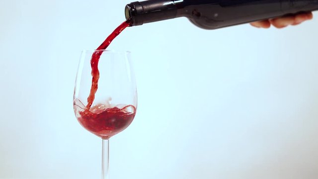 Red wine pouring from the bottle into a glass