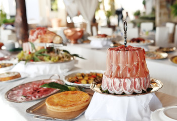 Bacon and speck slices, on background sweets and cold cuts