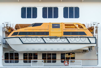 yellow rescue boat aboard an ocean liner