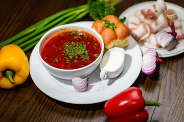 Borsch with greens and a penny with sour cream, decorations from vegetables