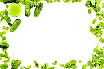 Green vegetables background with vegetable smoothies. Cucumber, arugula salad on white background top view copy space