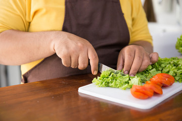 happy young man cooking his meal