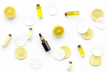 Natural organic cosmetics with lemon. Lemon oil or lotion, spa salt in small bottles on white background top view pattern