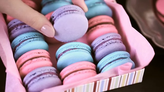 Row of colorful french macaroons in the box