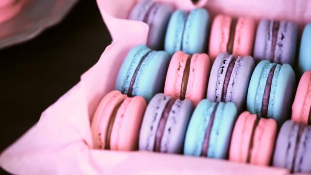 Row of colorful french macaroons in the box