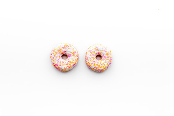 Unhealthy tasty sweets. Glazed donut on white background top view copy space