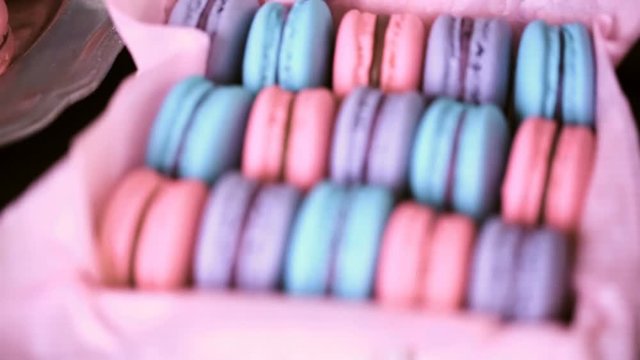 Row of colorful french macaroons in the box