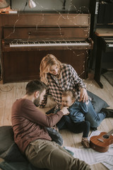 Happy young family playing on the floor