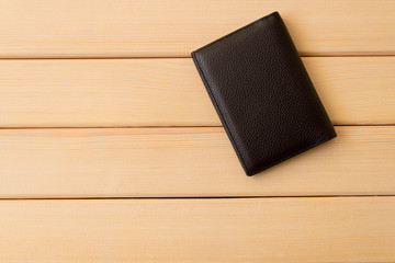 Leather wallet on wooden table background