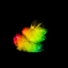 Multicolored powder explosion cloud isolated on black background. Freeze motion of color dust  particles splash.