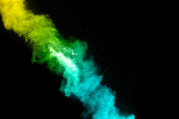 Multicolored powder explosion cloud isolated on black background. Freeze motion of color dust ...