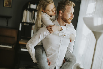 Loving couple kissing in the room