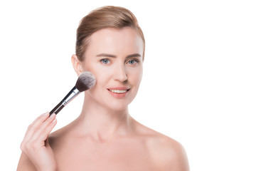 Woman with clean skin applying cosmetic powder isolated on white