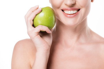 Cropped view of smiling female with clean skin holding apple isolated on white