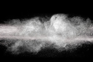 Launched white particle splash on black background. Bizarre forms of of white powder explosion...