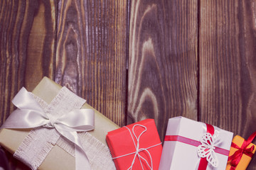 gifts in a different packages on a wooden background