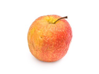 Old wrinkled apple isolated on white background seen from the side