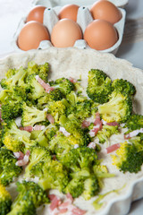 preparation of quiche with broccoli, eggs and bacon