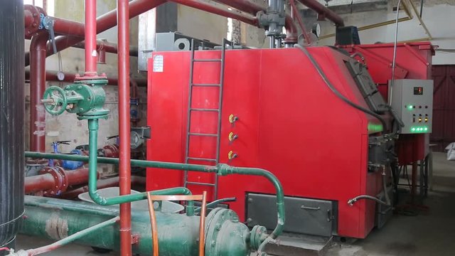 A large boiler for heating industrial premises with alternative fuels and wooden brackets