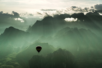 Taking a breathtaking hot air balloon ride over the city of Vang Viegn overlooking the stunning...