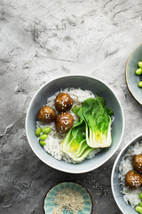Healthy home cooking. Meat balls teriyaki, rice, cabbage bok choy bowl with sesame seeds in a ceramic dish. Top View.