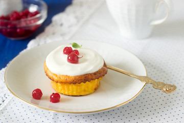 Mini cheesecake with whipped cream and red currant. Rustic style.