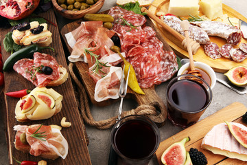 Italian antipasti wine snacks set. Cheese variety, Mediterranean olives, pickles, Prosciutto di Parma and salami