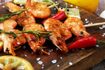 Grilled shrimp skewers. Seafood, shelfish. Shrimps Prawns skewers with herbs, garlic and lemon.
