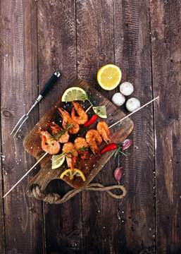 Grilled shrimp skewers. Seafood, shelfish. Shrimps Prawns skewers with herbs, garlic and lemon.